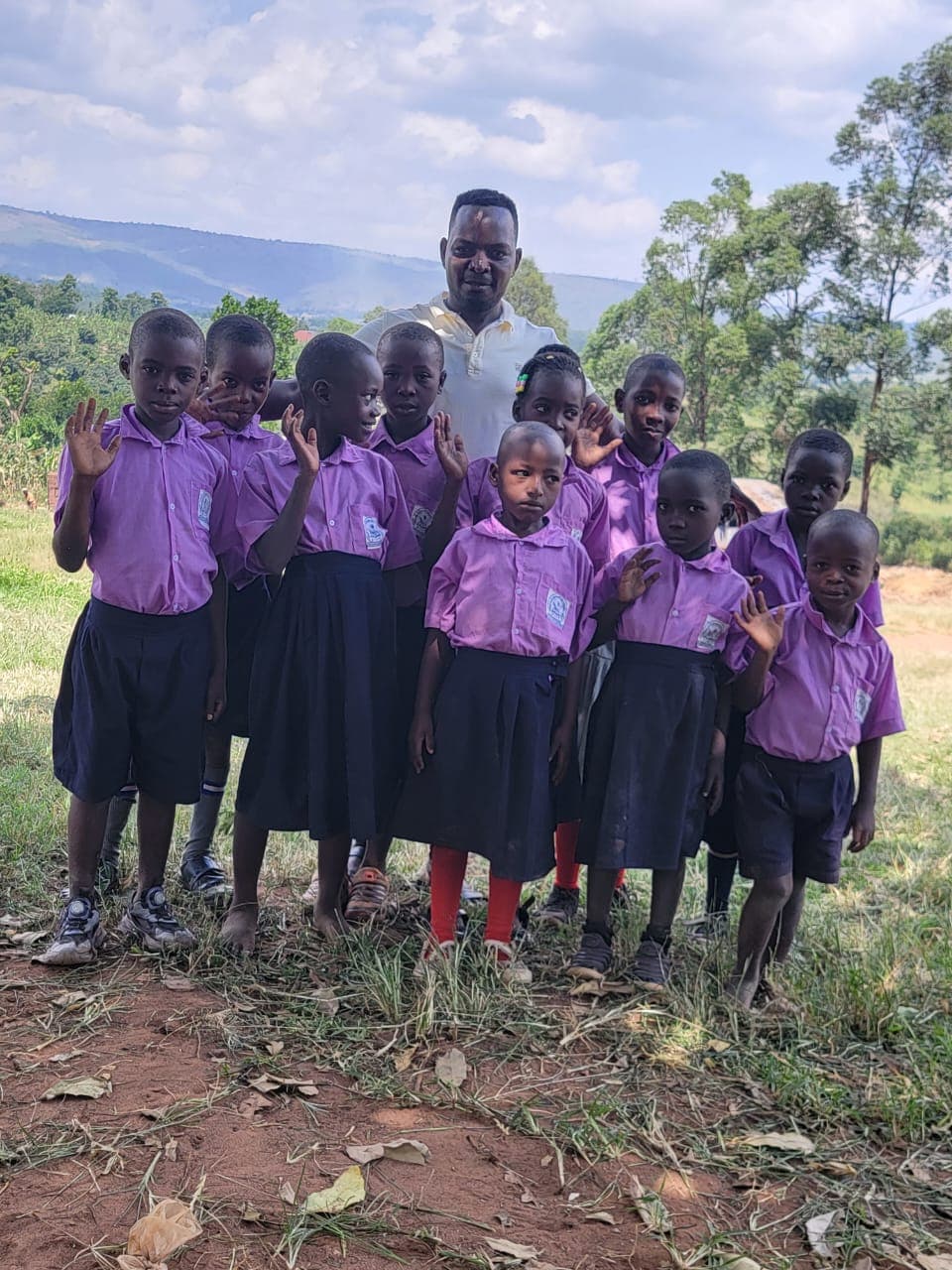 Children in school uniform waving